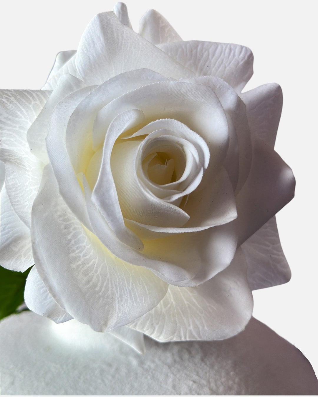 Extreme close-up macro shot of a Real-Touch Hybrid Tea Rose in white, showing the intricate petal veining and realistic matte texture of premium faux flowers.