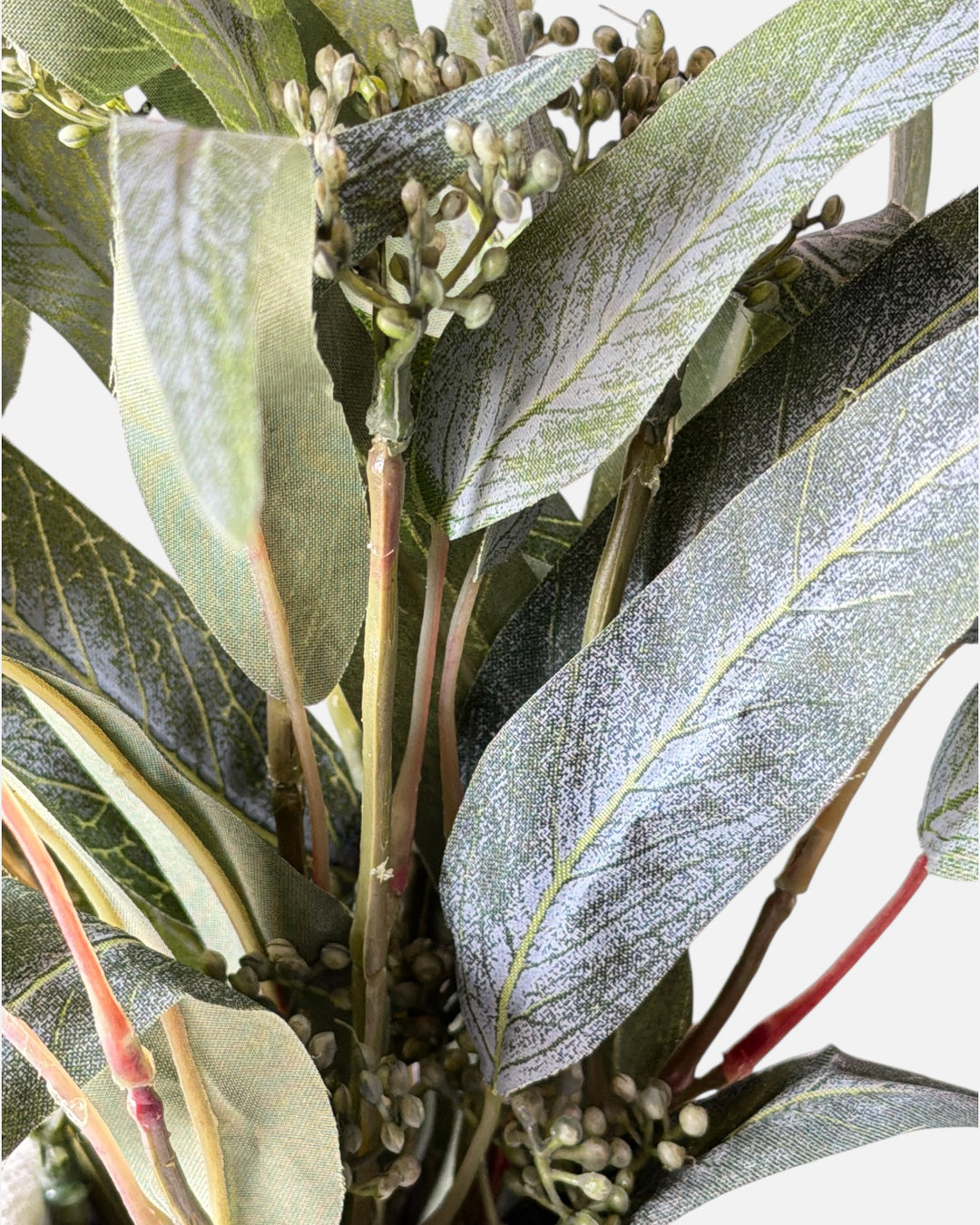 Detailed macro view of Seeded Willow Eucalyptus faux greenery, highlighting the frosted leaf finish and organic seed clusters for professional DIY arrangements